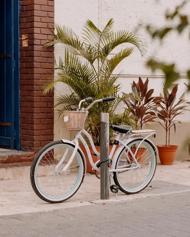 Bicycle parked on a street in Honolulu, Hawaiʻi, near a building entrance