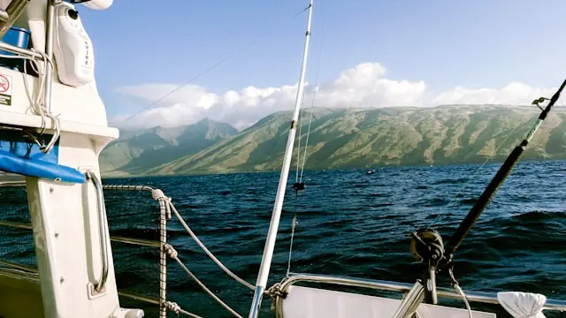 View from a boat on the ocean in Hawaiʻi with mountains in the background