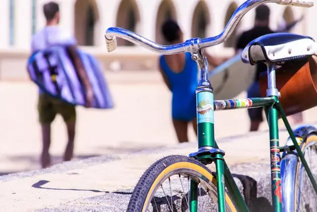 Bicycle parked near a beach in Honolulu, Hawaiʻi, with people in the background