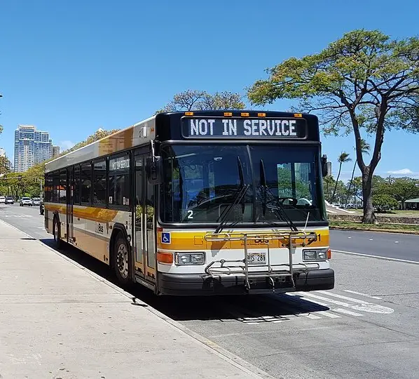 Public bus stopped at the curb in Honolulu with a not in service sign