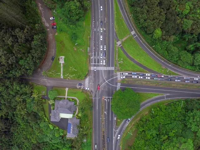 Aerial view of a multi-lane traffic intersection (Castle Junction in Kailua, Hawaiʻi) with cars turning and crossing