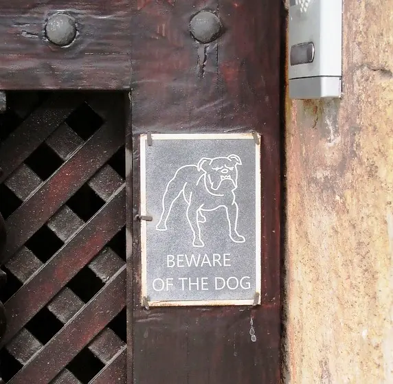 Beware of the dog sign posted at a residential front door entrance