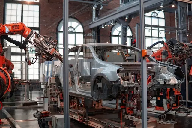 Vehicle being assembled on a manufacturing line with robotic equipment